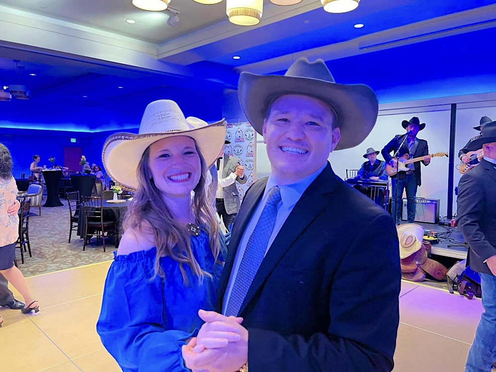 man and woman dancing with cowboy hats on