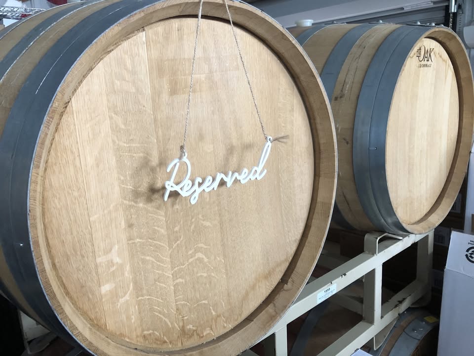 wine barrel with reserved sign hanging on it